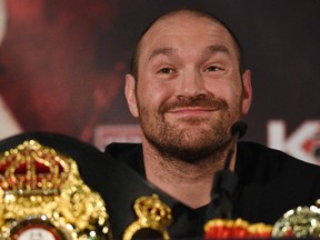 This file photo taken on April 27, 2016 shows British heavyweight boxer Tyson Fury reacts during a press conference to publicise his forthcoming world heavyweight title fight against Ukranian heavyweight Wladimir Klitschko, at the Manchester Arena in Manchester, north-west England. Controversial world heavyweight champion Tyson Fury made an abrupt U-turn on his retirement decision on October 3, 2016, tweeting: "I'm here to stay." "Hahahaha u think you will get rid of the GYPSYKING that easy!!! I'm here to stay," Fury wrote on Twitter.he provocative 28-year-old British brawler, dogged by reports he failed a drugs test for cocaine, had earlier declared himself "retired" in a profanity-strewn tweet.(OLI SCARFFOLI SCARFF/AFP/Getty Images)