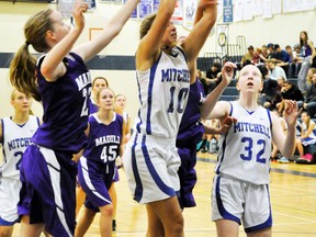 Erica Babb (11) of the Mitchell District High School (MDHS) senior girls basketball team grabs this rebound against two F.E. Madill (Wingham) opponents during Huron-Perth conference action Sept. 28. ANDY BADER MITCHELL ADVOCATE
