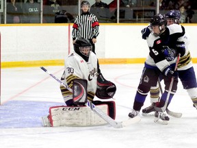 Despite the close coverage of Timmins Eagles defenceman Nicholas Tremblay, Ethan Corcoran of the Nickel City Sons tips a shot into the top corner of the net over the shoulder of Eagles goalie Tyler Marcotte on Sunday. The Sons downed the Eagles 12-1 on Saturday and 16-0 on Sunday to sweep the Timmins' bantam 'AAA' club's home-opening weekend. BENJAMIN AUBÉ/THE DAILY PRESS