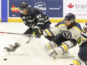 NIpissing Lakers Craig Campbell (92) battles Laurentian Voyageurs defenceman Kaden Ruest (4) at centre ice in front of a loud homecoming fan base in Memorial Gardens, Saturday. Dave Dale / The Nugget