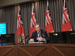 Premier Brian Pallister surrounded himself with five boxes of documents at a press conference Monday he said illustrates the magnitude of requests for new government funding.