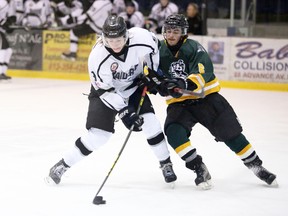 Dexter Hughson of the Napanee Raiders, left, gets ready to take a shot on goal while being guarded by Amherstview Jets defenceman Jordan Torres in a Provincial Junior Hockey League game Friday at Napanee's Strathcona Paper Centre. The Raiders, playing for the first time this season on their new home night, downed the Jets 3-1. (Meghan Balogh/Postmedia Network)