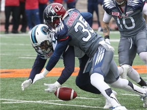 Montreal’s Greg Henderson (left) brings the ball down before  Argonauts’ RB Anthony Coombs can bring it in. In a year when Toronto is hosting the Grey Cup, the previously much-vaunted Argos have phoned it in, and have the losses to show for it.