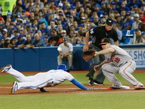 Blue Jays' Ezequiel Carrera dives back safely to first base during first inning MLB action against the Orioles at the Rogers Centre in Toronto on Sept. 27, 2016. (Stan Behal/Toronto Sun)