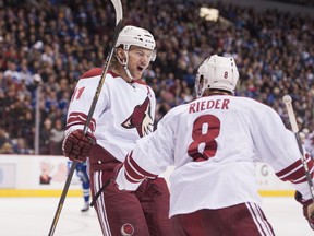 Arizona Coyotes Martin Hanzal celebrates with teammate Tobias Rieder after scoring his third goal of the game against the Vancouver Canucks during the second period of NHL hockey action at Rogers Arena in Vancouver, BC, November, 14, 2014. (Richard Lam/PNG)