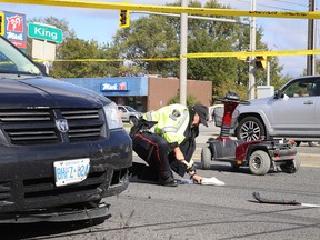 Constable Rick Carr, of the Greater Sudbury Police Service traffic management unit, places evidence markers at the scene where an elderly woman on a scooter was struck by a van at the corner of King street and Notre Dame Avenue on Oct. 3. The woman was sent to hospital with serious, life-threatening injuries. (Gino Donato/Sudbury Star)