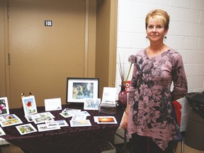Tracy Mozill stands beside her table full of her photography at the Milo Fall Fair held at the Milo Community School Saturday. Jasmine O'Halloran-Han