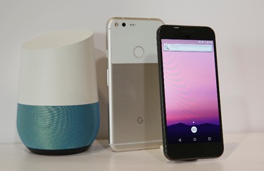 The new Google Pixel phone is displayed next to a Google Home smart speaker, left, following a product event, Tuesday, Oct. 4, 2016, in San Francisco. Google is making a greater commitment to hardware in unveiling new phones, a smart speaker and other gadgets. (AP Photo/Eric Risberg)