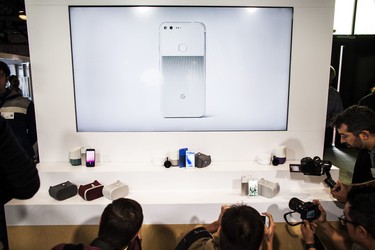 Members of the media photograph a display of Google's Pixel phone and other products during an event to introduce Google hardware products on October 4, 2016 in San Francisco. (Ramin Talaie/Getty Images)