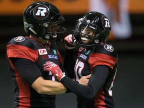 Ottawa Redblacks' quarterback Trevor Harris and Chris Williams celebrate Williams' touchdown against the B.C. Lions during the first half of a CFL football game in Vancouver on Oct. 1, 2016. (THE CANADIAN PRESS/Darryl Dyck)