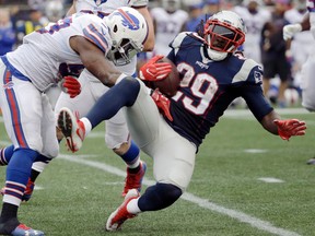 Bills’ Zach Brown (left) tackles Patriots’ LeGarrette Blount on Sunday. The Patriots were favoured, but lost 16-0. (AP)