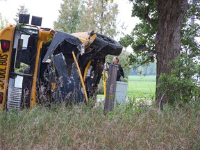 The driver of this school bus was pronounced dead at the scene Tuesday after crashing into a tree north of London on Twelve Mile Road, east of Adelaide Street. No one else was in the bus. (DEREK RUTTAN, The London Free Press)
