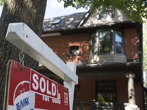 A house with a for sale sign indicating it was sold in Toronto (file photo/Postmedia Network)
