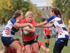 Loyalist (blue and white) vs. St. Lawrence in recent OCAA women's rugby action in Kingston. (SLC Athletics photo)