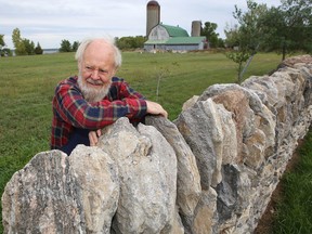 Master dry stone wall builder Norman Haddow, who is responsible for maintaining the stone structures at Balmoral Castle in Scotland, leans against a dry stone wall on Amherst Island. (Elliot Ferguson/The Whig-Standard)