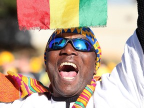 A supporter of Ghana holds a Ghanaian flag as he walks outside the Royal Bafokeng stadium as fans arrive for the Group D World Cup football match between Ghana and Australia on June 19, 2010. (AFP)