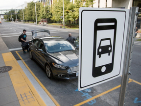 An Uber passenger meets his car at the new rideshare loading zone at the Ottawa International Airport. Wednesday October 5, 2016. Errol McGihon/Postmedia