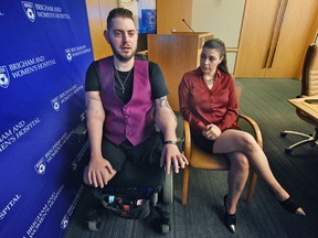 Retired Marine Sergeant John Peck speaks about his double arm transplant with his fiancee, Jessica Paker, Wednesday, Oct. 5, 2016 at Brigham and Women's Hospital in Boston. (Patrick Whittemore/The Boston Herald via AP)