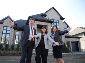 John MacFarlane, president of London Health Sciences Foundation, Tracy Loosemore, chief operating officer at Children?s Health Foundation, and Michelle Campbell, president of St. Joseph?s Health Care Foundation, show off the Dream Lottery grand prize home at 2337 Humberside Common in London. (DEREK RUTTAN, The London Free Press)