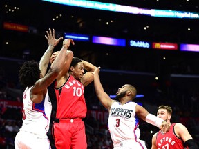 DeMar DeRozan #10 of the Toronto Raptors looks to pass as he is defended by DeAndre Jordan #6 and Chris Paul #3 of the Los Angeles Clippers as Jonas Valanciunas #17 trails the play during a preseason game at Staples Center on October 5, 2016 in Los Angeles, California. NOTE TO USER: User expressly acknowledges and agrees that, by downloading and or using this photograph, User is consenting to the terms and conditions of the Getty Images License Agreement. (Photo by Harry How/Getty Images)