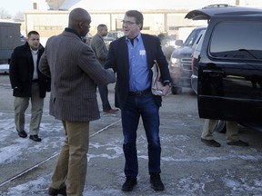 In this Feb. 20, 2015, file photo, U.S. Secretary of Defense Ash Carter, center, is greeted by Senior Military Assistant U.S. Army Maj. Gen. Ron Lewis as they arrive at Andrews Air Force Base, Md., to travel to Afghanistan. A Pentagon investigation concluded that Lewis, Carter's former senior military aide, used his government credit card at strip clubs or gentlemen's clubs in Rome and Seoul, drank in excess and had "improper interactions" with women, The Associated Press has learned. (Jonathan Ernst/Pool Photo via AP, File)