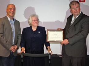 Submitted photo: Community Living Wallaceburg board members Derek McGivern, left, and Chris Taylor, right, present a 60th anniversary award to Carmen Poole, for her long-time efforts in establishing a vision for the agency and providing direction for the organization, as well as being a champion and supporter of full inclusion for people. Poole, along with six others, was honoured with 60th anniversary awards at Community Living Wallaceburg's annual general meeting held on Sept. 29.