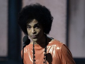 This file photo taken on February 8, 2015 shows musician Prince presets an award on stage at the 57th Annual Grammy Awards in Los Angeles February 8, 2015. (ROBYN BECK/AFP/Getty Images)