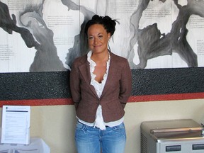 In this July 24, 2009, file photo, Rachel Dolezal, a leader of the Human Rights Education Institute, stands in front of a mural she painted at the institute's offices in Coeur d'Alene, Idaho. Dolezal, the former NAACP chapter president who made headlines in 2015 when her race came into question, has been tapped to speak at a Martin Luther King Day celebration set for January in Cary, N.C. (AP Photo/Nicholas K. Geranios, File)