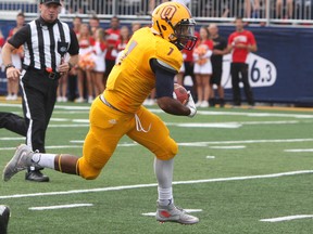 Queen's Golden Gaels’ Nicholas Fraser-Greene returns a punt against the Western Mustangs during an Ontario University Athletics football game at Richardson Stadium on Sept. 17. (Steph Crosier/The Whig-Standard)
