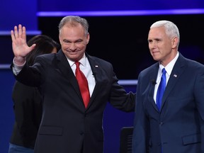 Democrat Tim Kaine (L) and Republican Mike Pence (R) arrive on stage for the U.S. vice-presidential debate at Longwood University in Farmville, Virginia on October 4, 2016. (AFP PHOTO/Paul J. Richards)