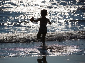 Three year old Ariadne Vallejos of London plays in the surf of Lake Erie at Port Stanley Beach in Port Stanley Ont. on Thursday October 6, 2016. She was enjoying the day with her grandmother Valerie Vallejos. (DEREK RUTTAN, The London Free Press)