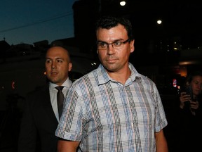 Ken Pagan, accompanied by his lawyer Tyler Smith, Toronto Police arrives at 52 Division on Thursday October 6, 2016. (Stan Behal/Toronto Sun)