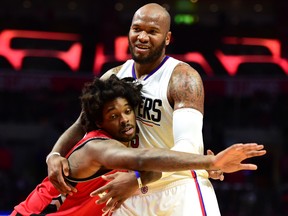 Marreese Speights of the Los Angeles Clippers gets tangled with Lucas Nogueira of the Toronto Raptors during a pre-season game at Staples Center on Oct. 5, 2016 in Los Angeles. (Harry How/Getty Images)