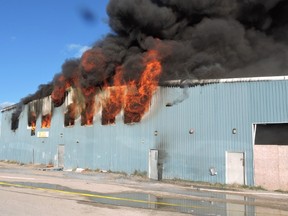 Fire engulfs a building in Shamattawa, Manitoba in this RCMP handout image. RCMP say a fire that destroyed the only food store on a remote Manitoba reserve was set by several kids.The fire erupted Sept. 22 in Shamattawa, and destroyed the community's grocery store, band office, radio station and 9-1-1 centre. (THE CANADIAN PRESS/HO)