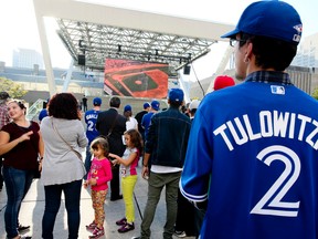Fans in the Bird's Nest outside Toronto City Hall watch the Blue Jays face the Texas Rangers in the first game of the ALDS on Thursday October 6, 2016. (Veronica Henri/Toronto Sun)