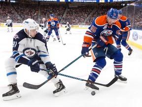 Winnipeg Jets' Alexander Burmistrov (91) and Edmonton Oilers' Mark Letestu (55) battle for the puck during first period NHL pre-season action in Edmonton, Alta., on Thursday October 6, 2016.