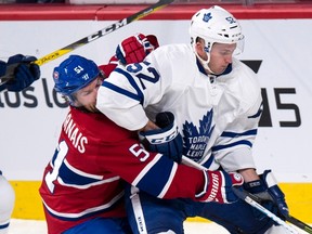 Canadiens forward David Desharnais hangs on to Maple Leafs defenceman Martin Marincin during second period NHL pre-season action in Montreal on Thursday, Oct. 6, 2016. (Paul Chiasson/The Canadian Press)