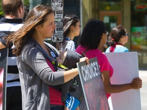 Anti-abortion protestors hold graphic signs picturing aborted fetuses during a protest in downtown London. A similar event in Strathroy got Jamie Greenwood thinking about the need to keep an open mind and respect others? beliefs. (MIKE HENSEN/The London Free Press file photo)