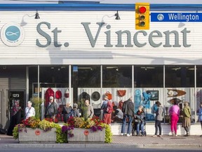 Customers line up outside St. Vincent de Paul thrift store on Wellington Street on Friday before the store's 9 a.m. opening, hoping to be first to get at the items in the window. BRUCE DEACHMAN