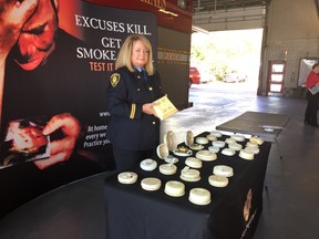 London fire prevention officer Wendy Cowdrey shows 20 expired smoke alarms found in London homes.  (JANE SIMS, The London Free Press)