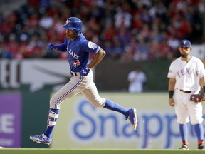 Toronto Blue Jays' Melvin Upton Jr. rounds the bases on his solo home run as Texas Rangers second baseman Rougned Odor watches during the fourth inning of Game 1 of baseball's American League Division Series. Thursday, Oct. 6, 2016, in Arlington, Texas. (AP Photo/LM Otero)