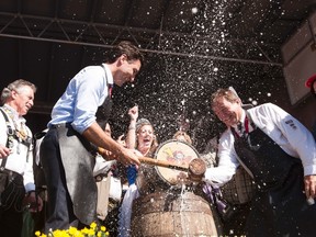 Prime Minister Justin Trudeau helps tap the keg at the opening ceremony for Oktoberfest in Kitchener, Ont., on Friday, Oct. 7, 2016. THE CANADIAN PRESS/Hannah Yoon