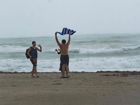 People play in the rain and wind caused by Hurricane Matthew on October 6, 2016 in Miami Beach, Florida. (Gaston De Cardenas/Getty Images)