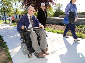 David Grightmire, a team member of the Queen’s University Built Environment Working Group, tries out a new accessible ramp at Queen’s Duncan McArthur Hall on Wednesday. (Ian MacAlpine/The Whig-Standard)