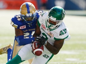 Winnipeg Blue Bombers' Bruce Johnson, seen here stripping the ball from the hands of Saskatchewan Roughriders' Ricky Collins Jr. earlier this season, has been suspended for two games. (THE CANADIAN PRESS/John Woods file photo)