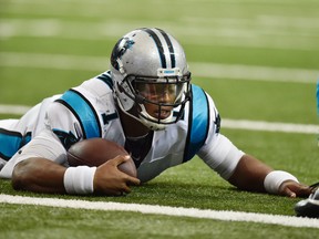 In this Oct. 2, 2016, file photo, Carolina Panthers quarterback Cam Newton lies on the turf after being hit against the Atlanta Falcons during the second half of a game in Atlanta. (AP Photo/Rainier Ehrhardt, File)