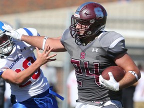 South's Nick Morello stiff arms Oak's Connor Galloway on a run during their game at South Friday afternoon in London, Ont.  The Lions won 35-0. (MIKE HENSEN, The London Free Press)