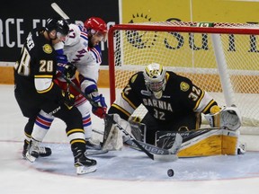 Sarnia Sting goalie Justin Fazio tracks the puck while teammate Kelton Hatcher boxes out Kitchener Rangers forward Mason Kohn during the Ontario Hockey League game at Kitchener Memorial Auditorium on Friday, Oct. 7, 2016 in Kitchener, Ont. The Rangers and Sting played against each other for the first time this season. (Terry Bridge/Sarnia Observer)