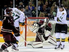 Robert Thomas and Sam Miletic of the Knights tries to deflect a shot past Scott Smith of the Pete's during a late first period powerplay during their Friday night OHL game against the Peterborough Pete's at Budweiser Gardens in London, Ont. (MIKE HENSEN, The London Free Press)