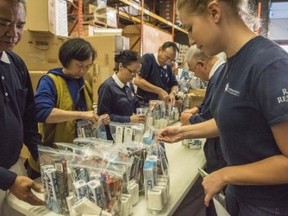 Volunteers pack up emergency aid packages. (VICTOR BIRO PHOTO)